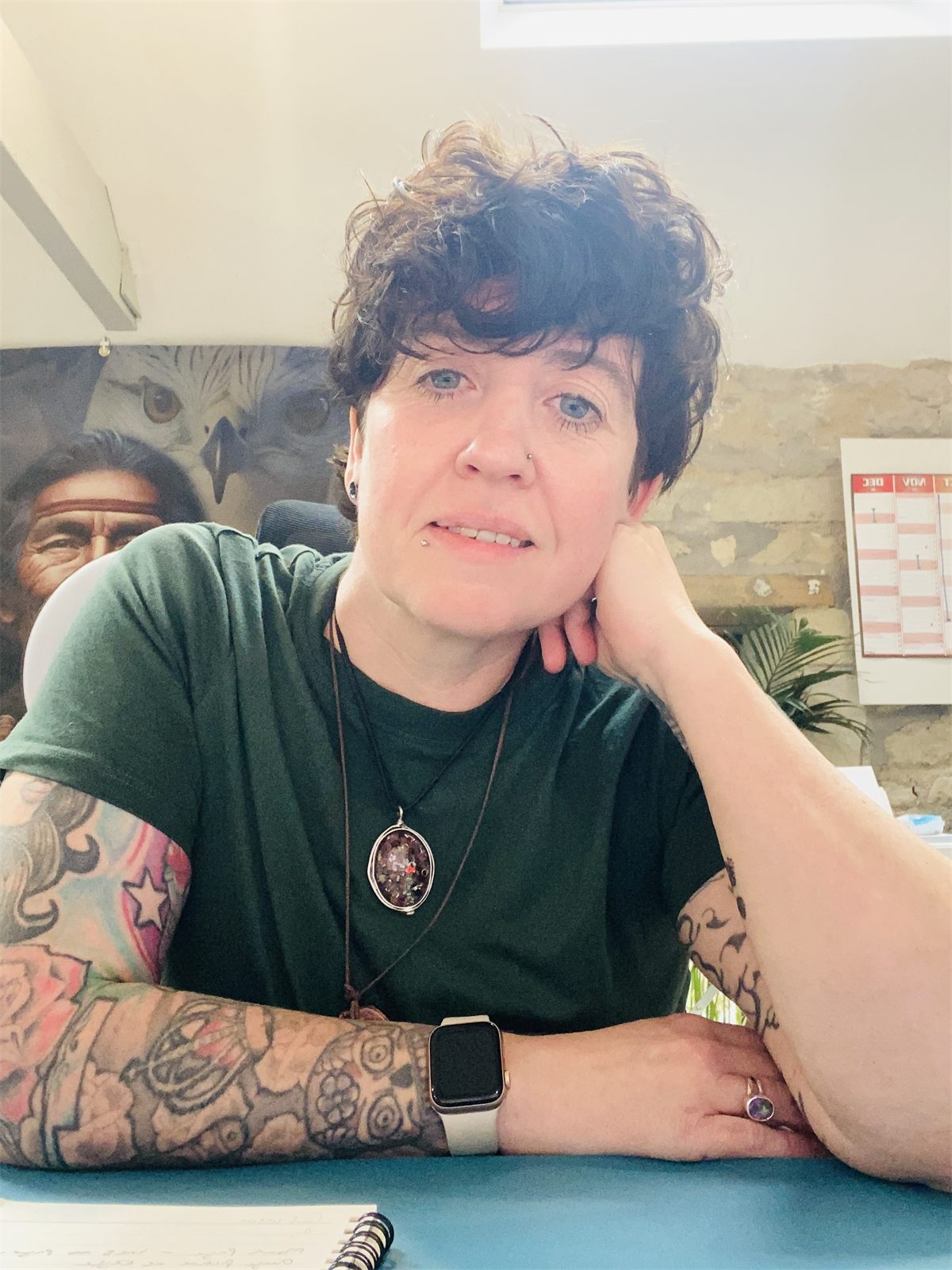 Ruth, founder of Alternative Healings, seated at a table